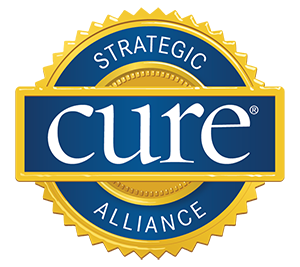 A blue and yellow badge with the word " cure " written underneath it.